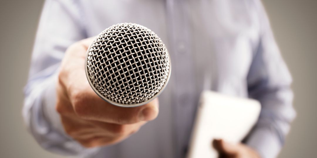 Man is holding a microphone in his hand.