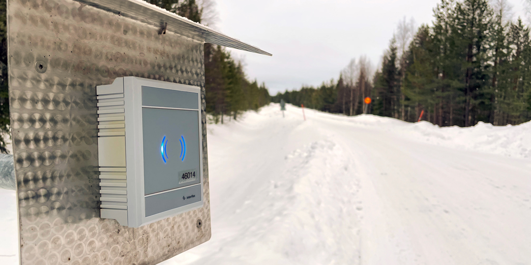 Schranke mit Interflex-Zutrittsterminal an schneebedeckter Straße